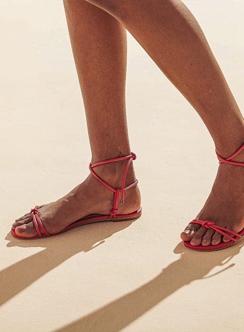 Flat vegan toe-strap sandal by Arenaria - red